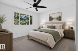 Bright room featuring a large multi-pane window, flush-mount ceiling fan, and light gray carpet - 