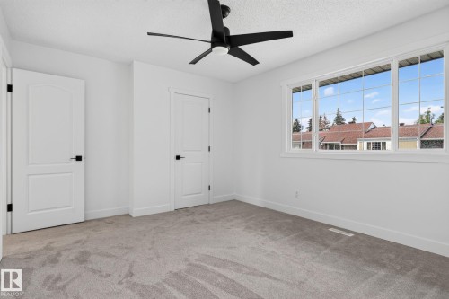 Spacious room featuring light gray carpeting and white walls - 8059 178 Street Nw, Edmonton, AB - Indoor Photo Showing Other Room