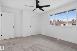 Spacious room featuring light gray carpeting and white walls - 