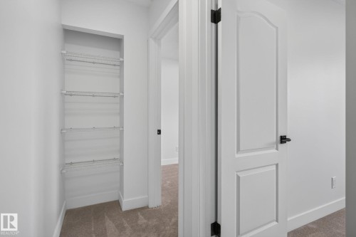 Recessed shelving unit featuring four wire racks - 8059 178 Street Nw, Edmonton, AB - Indoor Photo Showing Other Room