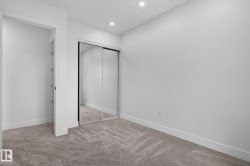 Bedroom featuring grey carpet flooring, recessed lighting, white walls, and a mirrored sliding closet door - 