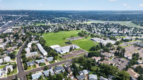 Aerial perspective showcasing a residential area with extensive green spaces, a large institutional building, and established infrastructure - 8059 178 Street Nw, Edmonton, AB - Outdoor With View