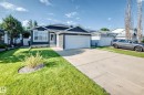 Contemporary home featuring dark blue siding, a white trim window bay, and an attached two-car garage - 3729 131A Avenue Nw, Edmonton, AB  - Outdoor With Facade 