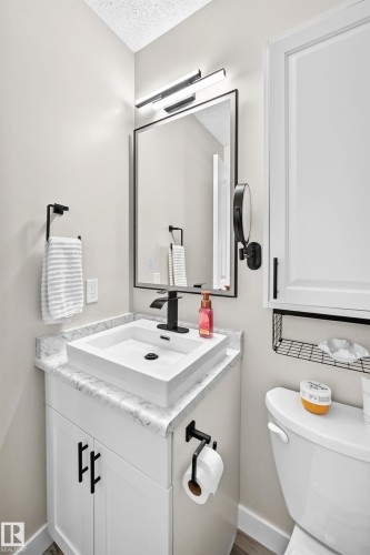 Contemporary vanity featuring a rectangular vessel sink, black faucet, and white countertop - 3729 131A Avenue Nw, Edmonton, AB - Indoor Photo Showing Bathroom