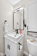 Contemporary vanity featuring a rectangular vessel sink, black faucet, and white countertop - 