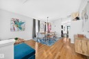 Bright dining space featuring wood-finish flooring, a modern chandelier, and light gray walls - 3729 131A Avenue Nw, Edmonton, AB  - Indoor 