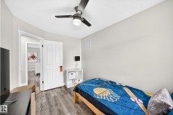 Room featuring wood-finish flooring and a ceiling fan with integrated lighting - 