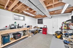 Lower level utility space with exposed wood joists and ductwork - 