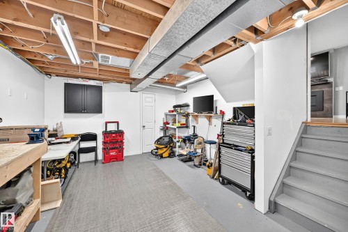 Finished basement space featuring exposed ceiling joists, overhead fluorescent lighting, and a neutral-toned floor - 3729 131A Avenue Nw, Edmonton, AB - Indoor Photo Showing Basement