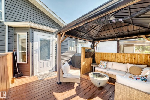 Expansive outdoor deck featuring wood-finish flooring, a built-in privacy wall, and an attached gazebo structure - 3729 131A Avenue Nw, Edmonton, AB - Outdoor With Deck Patio Veranda With Exterior