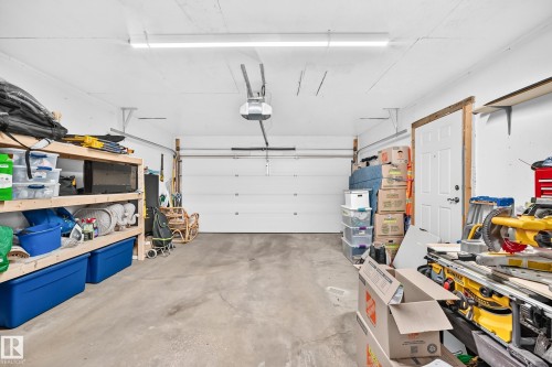 Concrete-floored garage with a white overhead door and an automatic opener - 3729 131A Avenue Nw, Edmonton, AB - Indoor Photo Showing Garage