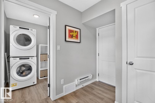 Main Floor Foyer of the Home leading to Laundry, Garage, and Staircase. - 1051 Cy Becker Road Nw, Edmonton, AB - Indoor Photo Showing Laundry Room