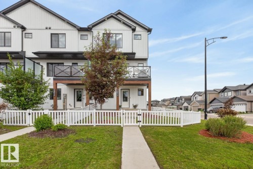 Front of Home located on a Landscaped Corner Lot. Fully Fenced with Front and Side Entrance. - 1051 Cy Becker Road Nw, Edmonton, AB - Outdoor With Balcony With Facade