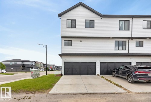 Exterior Back of House featuring Double Garage and Parking Pad. - 1051 Cy Becker Road Nw, Edmonton, AB - Outdoor
