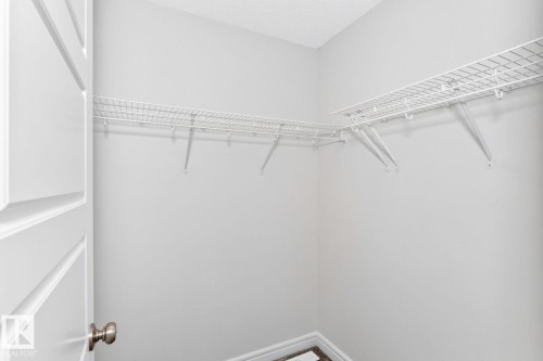 Walk-in closet featuring wire shelving, white painted walls, and textured ceiling - 1261 Rosenthal Boulevard Nw, Edmonton, AB - Indoor With Storage