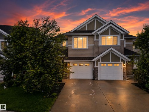 Two-story residence featuring light brown siding and stone accents - 2155 67 Street Sw, Edmonton, AB - Outdoor With Facade