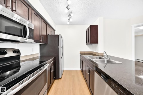#206 3315 James Mowatt Tr Sw, Edmonton, AB - Indoor Photo Showing Kitchen With Double Sink
