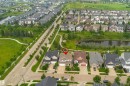 Aerial perspective showcasing a residential area with a prominent pond and green spaces - 2338 Frezenberg Avenue Nw, Edmonton, AB  - Outdoor With Body Of Water With View 