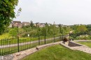 Landscaped backyard featuring paver stone patio, stone retaining walls, and a manicured lawn - 2338 Frezenberg Avenue Nw, Edmonton, AB  - Outdoor 