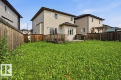 Expansive backyard featuring a wood deck, sliding glass door access, and a bay window - 