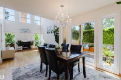 Spacious dining area featuring a crystal chandelier and direct access to an outdoor patio - 