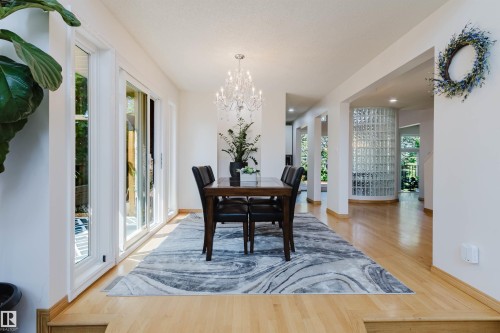 Light wood-finish flooring extending through the space - 342 O'Connor Close Nw, Edmonton, AB - Indoor Photo Showing Dining Room