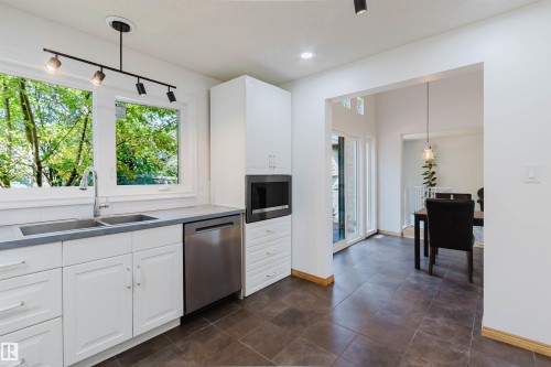 Modern kitchen featuring white cabinetry, stainless steel appliances, and a double basin sink - 342 O'Connor Close Nw, Edmonton, AB - Indoor Photo Showing Kitchen With Double Sink