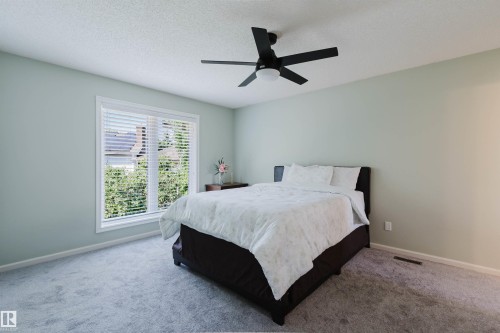 Spacious room featuring light-toned wall paint and a textured ceiling - 342 O'Connor Close Nw, Edmonton, AB - Indoor Photo Showing Bedroom