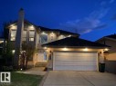 Exterior stucco residence featuring a prominent chimney, multiple large windows, and a two-car garage - 342 O'Connor Close Nw, Edmonton, AB  - Outdoor 
