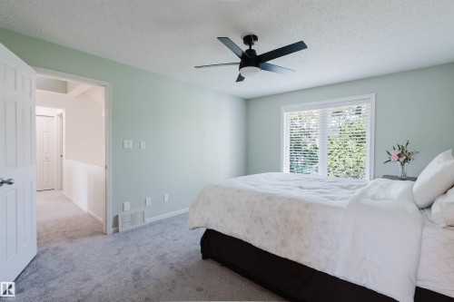 This room features light green walls and soft gray carpeting - 342 O'Connor Close Nw, Edmonton, AB - Indoor Photo Showing Bedroom
