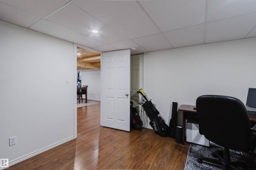 Finished interior space featuring wood-finish flooring, white walls, and a drop ceiling with recessed lighting - 342 O'Connor Close Nw, Edmonton, AB - Indoor Photo Showing Office