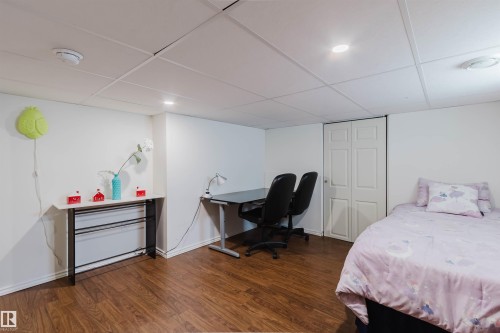 Interior space featuring wood-finish flooring and a white drop ceiling with recessed lighting - 342 O'Connor Close Nw, Edmonton, AB - Indoor Photo Showing Bedroom