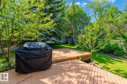 Tiered wood-finish deck with ample outdoor space, surrounded by mature trees and manicured lawn - 342 O'Connor Close Nw, Edmonton, AB - Outdoor With Deck Patio Veranda