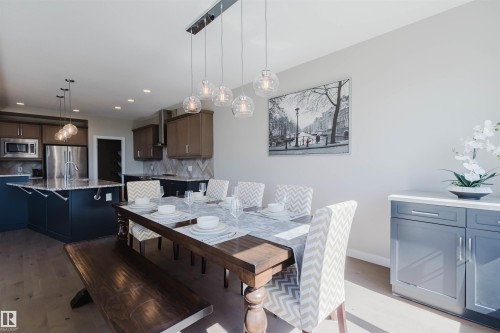 Spacious open-concept interior featuring light wood-finish flooring - 4125 Kennedy Green Sw, Edmonton, AB - Indoor