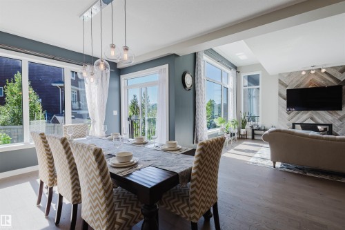 Open-concept living space with dark wood-finish flooring - 4125 Kennedy Green Sw, Edmonton, AB - Indoor Photo Showing Dining Room