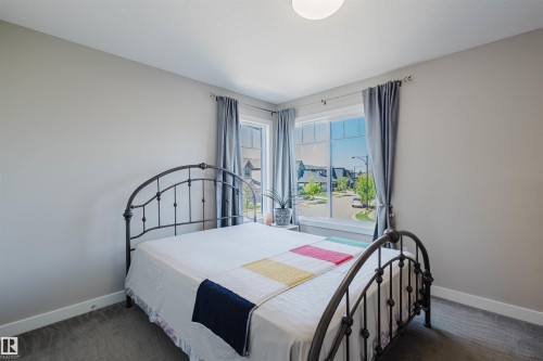 Spacious room featuring neutral paint, soft grey carpet, and white baseboards - 4125 Kennedy Green Sw, Edmonton, AB - Indoor Photo Showing Bedroom