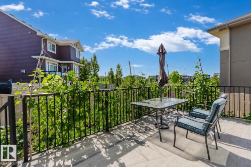 Outdoor deck featuring a black metal railing and concrete-finish flooring - 4125 Kennedy Green Sw, Edmonton, AB - Outdoor With Deck Patio Veranda With Exterior