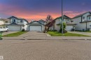 Single-family dwelling featuring a two-car garage, concrete driveway, and a manicured front lawn - 16737 116 Street Nw, Edmonton, AB  - Outdoor With Facade 