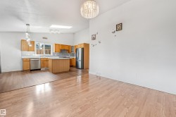 Open-concept living space with wood-finish flooring - 