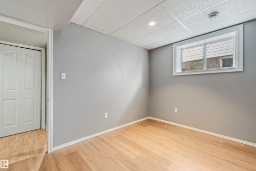 Room featuring wood-finish flooring and a neutral color palette - 16737 116 Street Nw, Edmonton, AB 