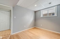 Room featuring wood-finish flooring and a neutral color palette - 