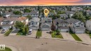 Suburban neighborhood featuring multiple detached homes with attached garages, paved driveways, and manicured front lawns - 16737 116 Street Nw, Edmonton, AB  - Outdoor With Facade 