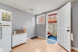 Utility space featuring wood-finish flooring and a drop ceiling - 