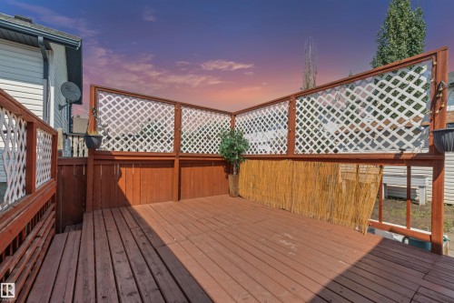 Expansive wood deck with a privacy lattice and bamboo screening - 16737 116 Street Nw, Edmonton, AB 