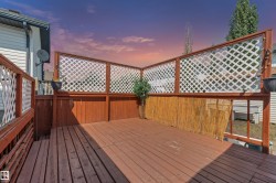 Expansive wood deck with a privacy lattice and bamboo screening - 