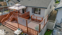 Multi-level wood deck featuring a covered gazebo, staircase access, and privacy lattice railings - 