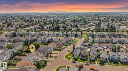 Residential neighborhood setting featuring single-family homes and mature landscaping - 