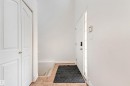Foyer featuring tile flooring, white walls, and a white entry door with a sidelight - 16737 116 Street Nw, Edmonton, AB  - Indoor Photo Showing Other Room 