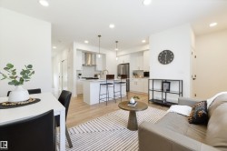 Open-concept living space featuring wood-finish flooring and recessed lighting - 
