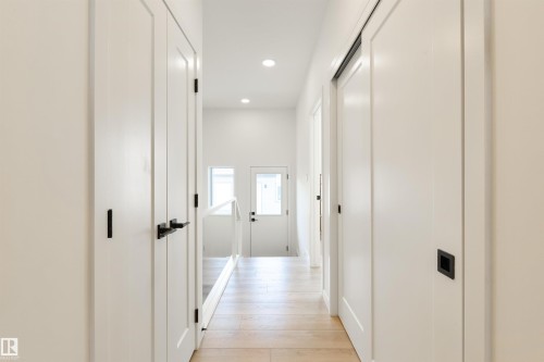 Hallway with light wood-finish flooring, white walls, and recessed lighting - 323 Rankin Drive, St. Albert, AB - Indoor Photo Showing Other Room